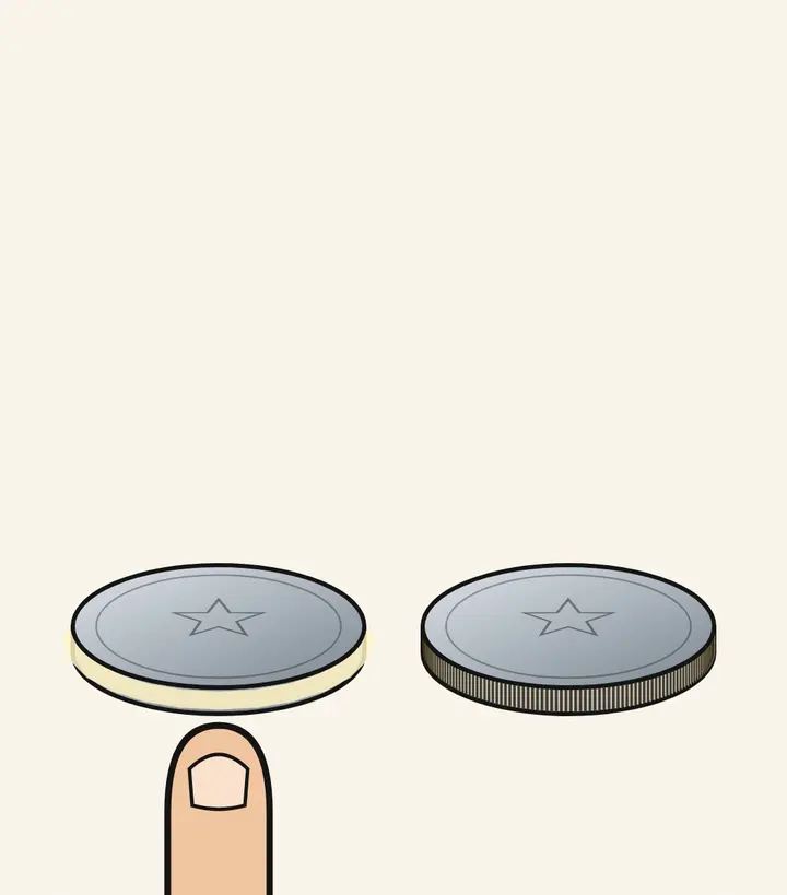 A fingertip below two silver coins, one with a smooth edge and one with a ridged edge